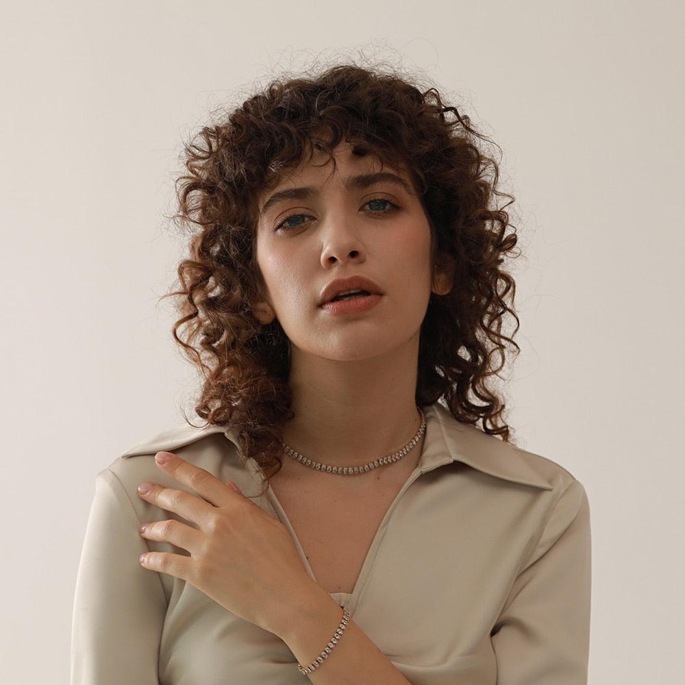 woman wearing silver tennis bracelet and necklace